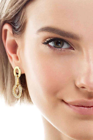 a close up of a person wearing a pair of earrings