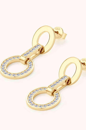 a pair of gold earrings with a chain