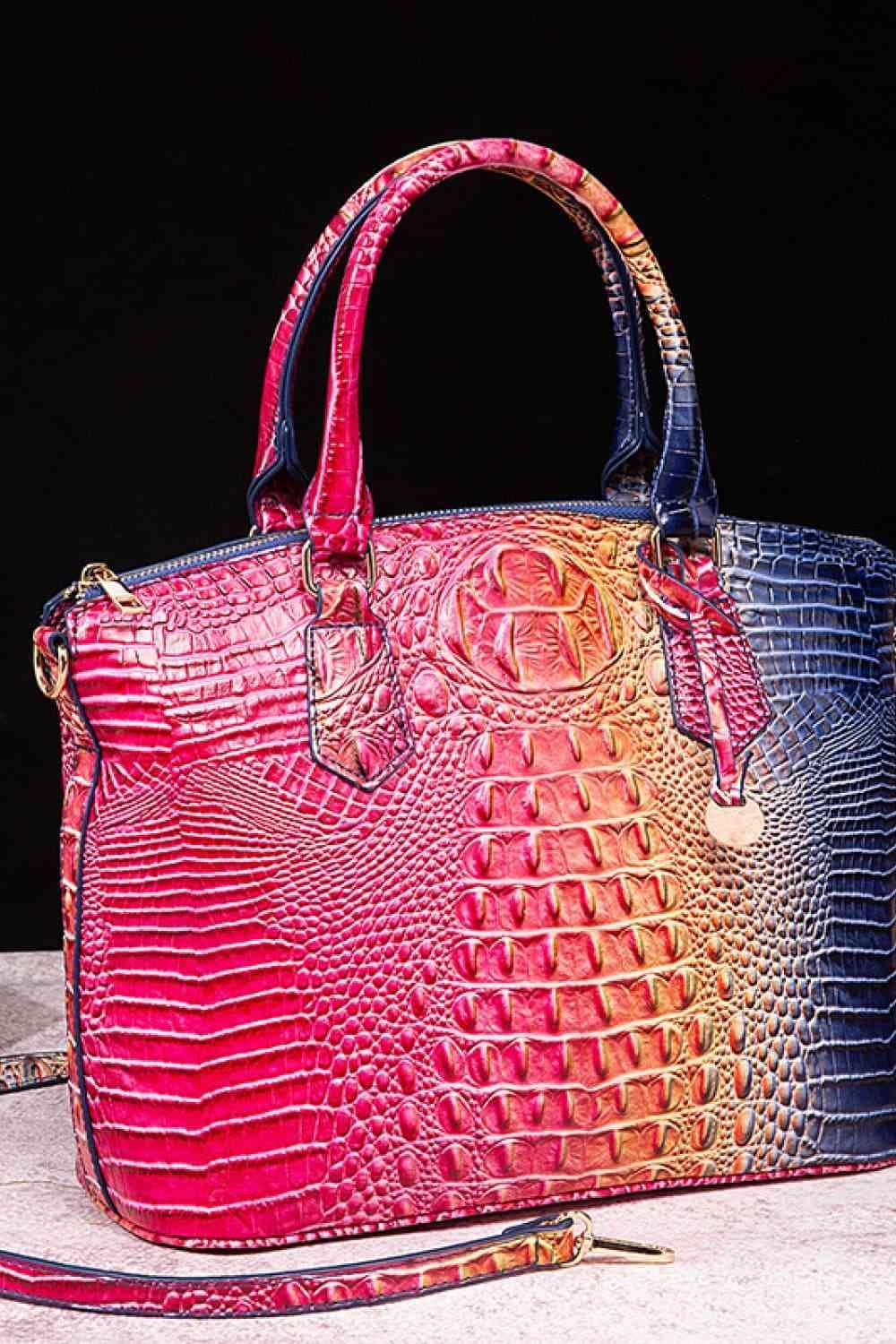 a pink and blue purse sitting on top of a table