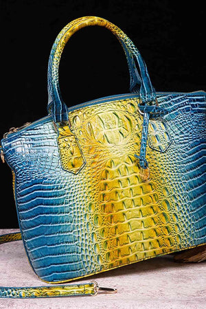 a blue and yellow purse sitting on top of a table