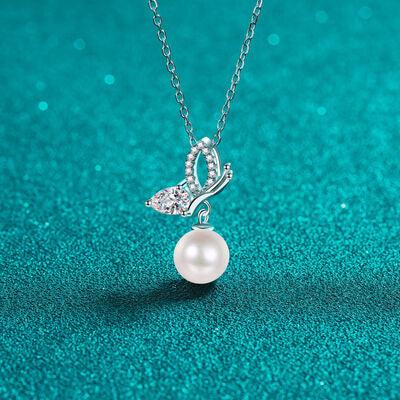 a necklace with a pearl and a butterfly on it