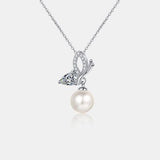 a necklace with a butterfly and a pearl