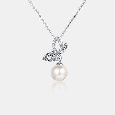 a necklace with a butterfly and a pearl
