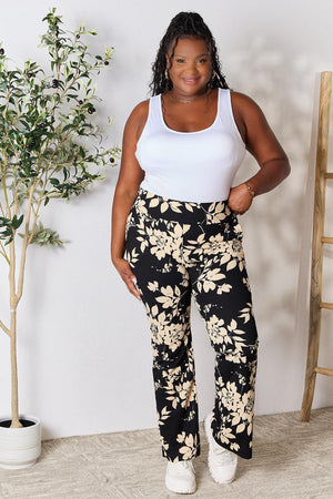 a woman standing in front of a plant