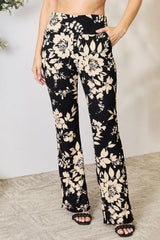a woman wearing a black and white floral print pants