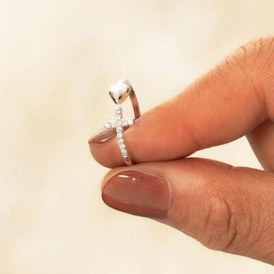 a woman's hand holding a diamond ring