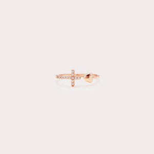 a rose gold ring with a cross on it