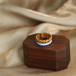 a wooden box with a ring on top of it