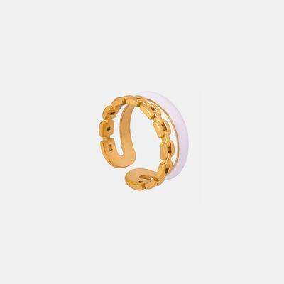 a gold ring on a white background