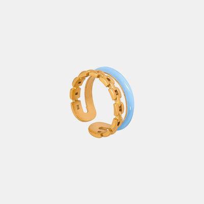 a gold and blue ring on a white background