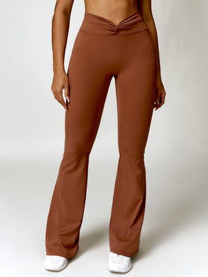 a woman in brown pants posing for a picture