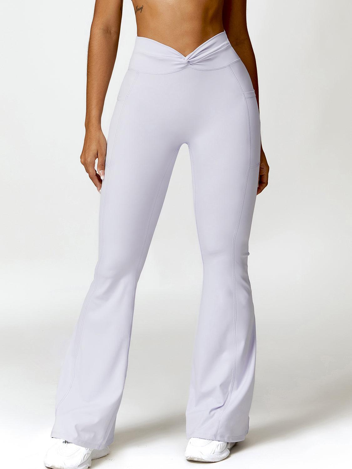 a woman in white pants is posing for a picture