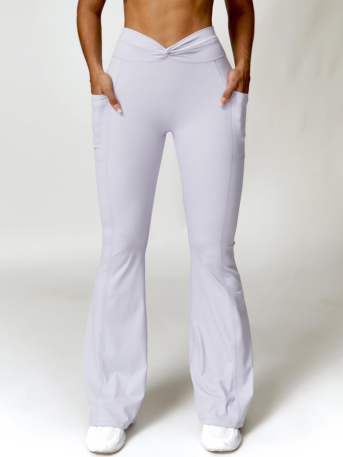 a woman in white pants is posing for a picture