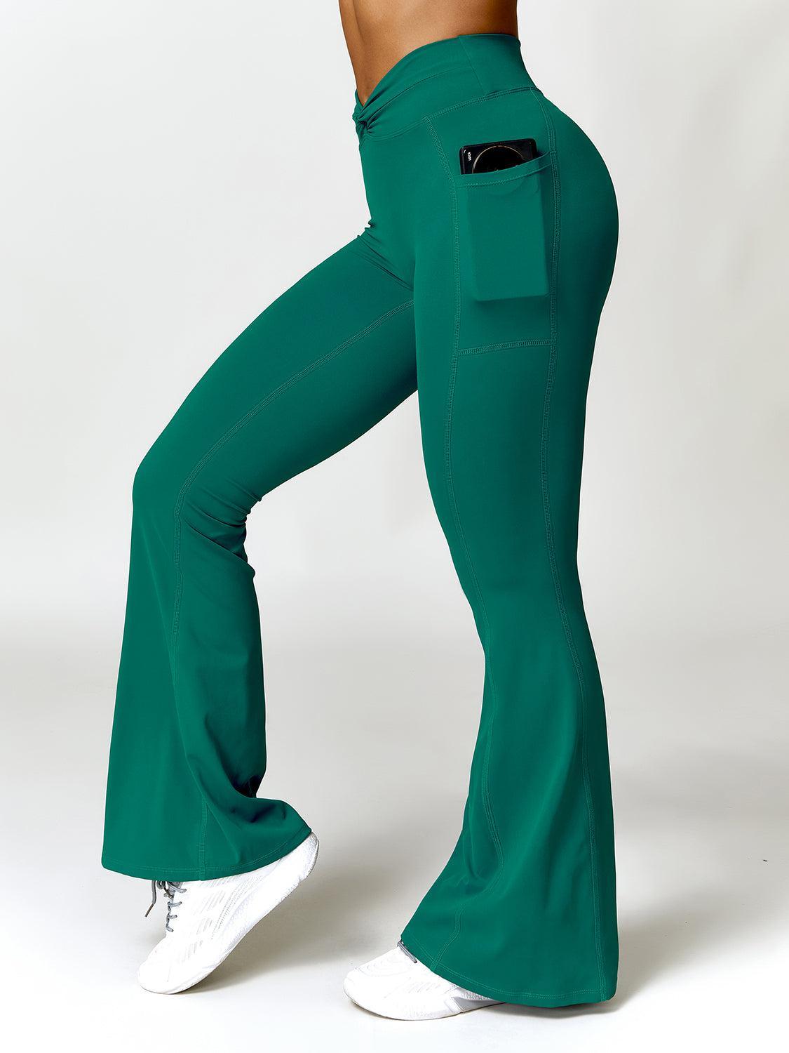 a woman in green pants and white sneakers