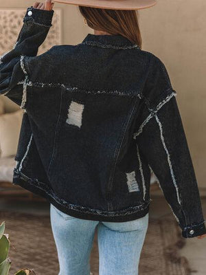 a woman wearing a hat and a jean jacket