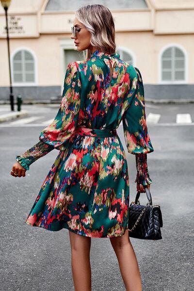 a woman in a green floral print dress