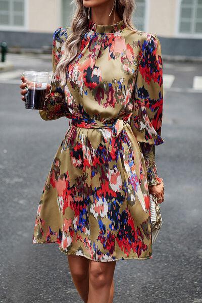 a woman walking down a street holding a drink