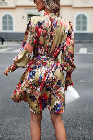 a woman in a floral print dress is walking down the street