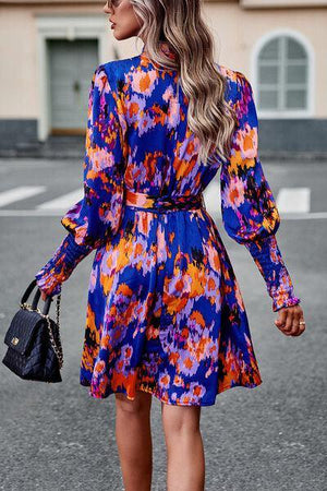 a woman in a colorful dress is walking down the street