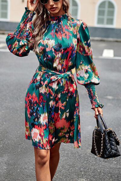 a woman in a floral print dress is walking down the street