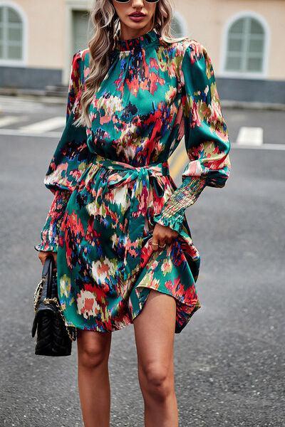 a woman in a green floral dress is walking down the street