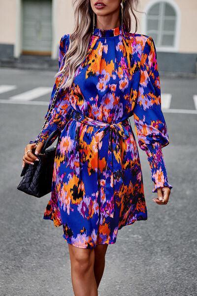 a woman walking down a street wearing a colorful dress