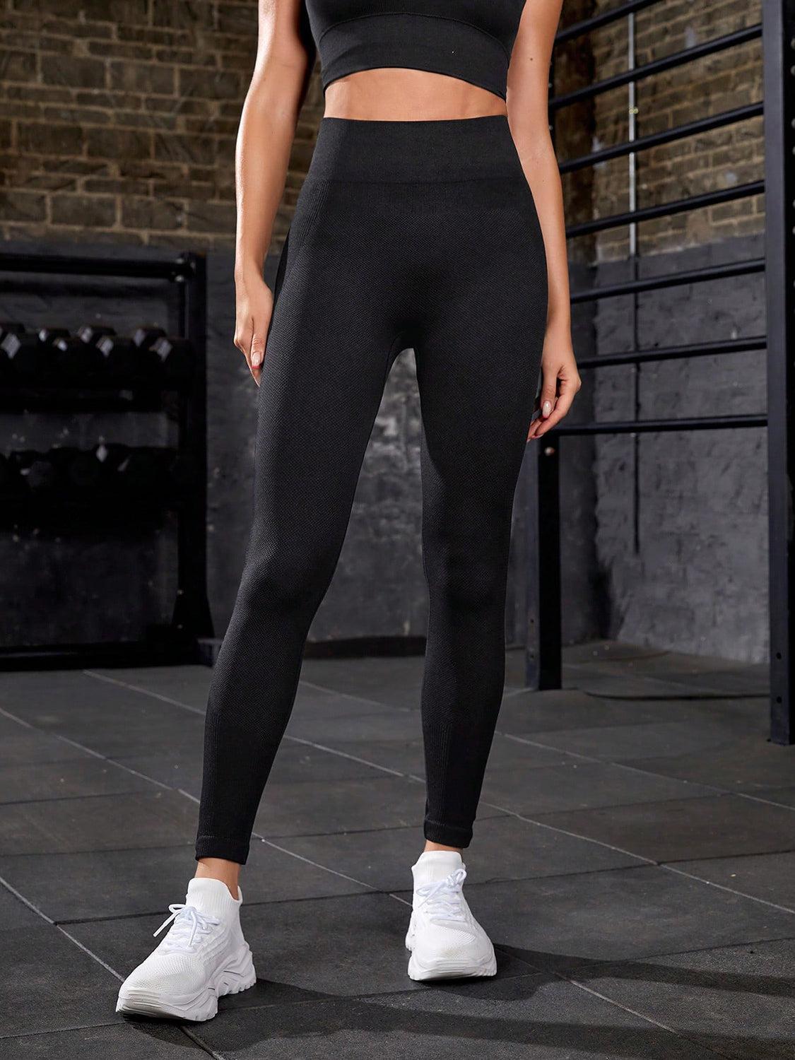 a woman in black sports bra top and leggings
