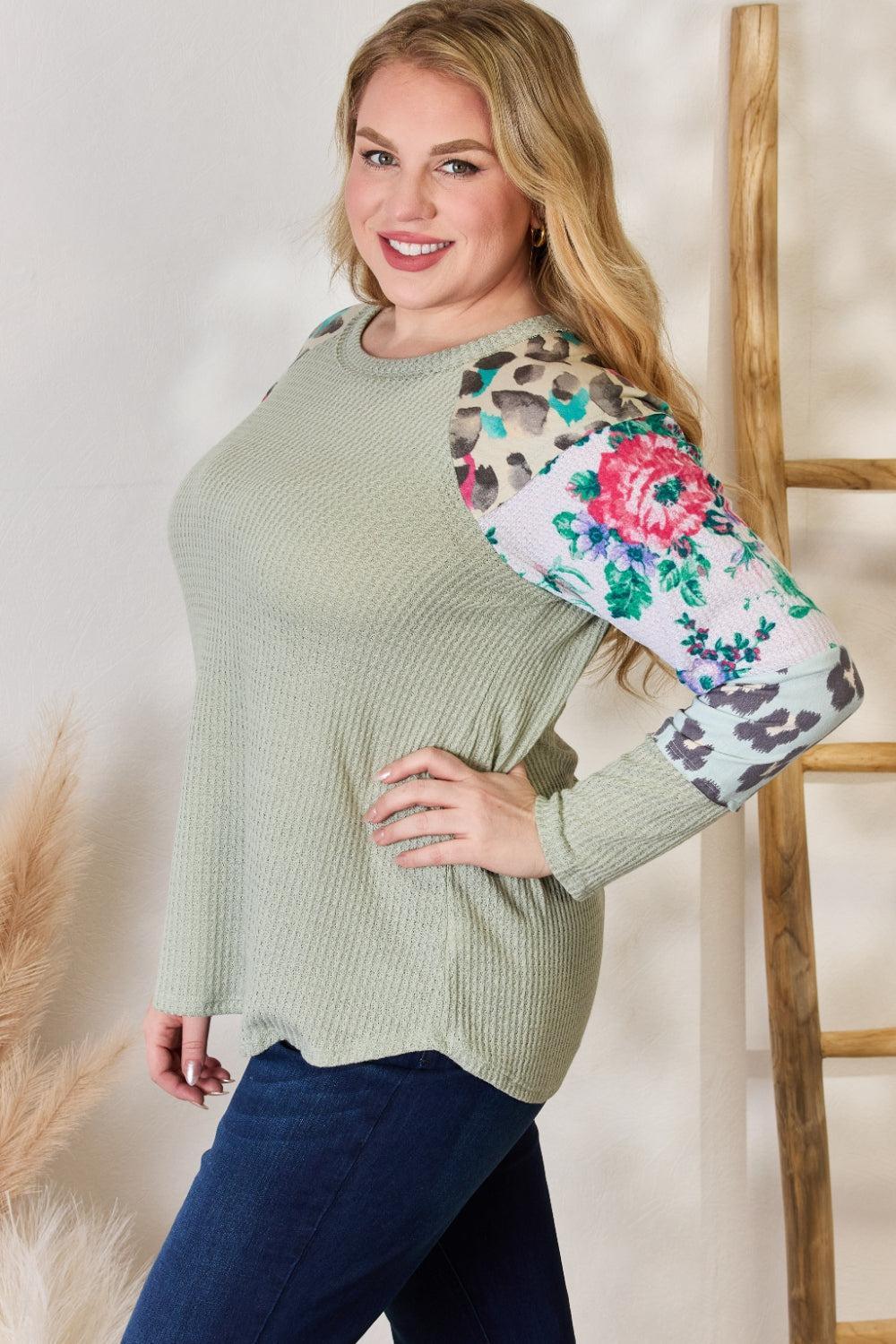 a woman posing for a picture in a green top