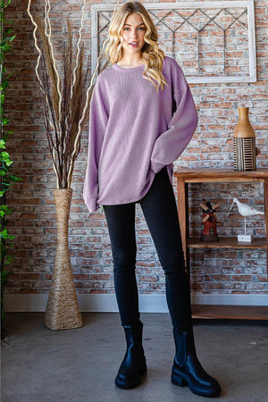 a woman standing in front of a brick wall