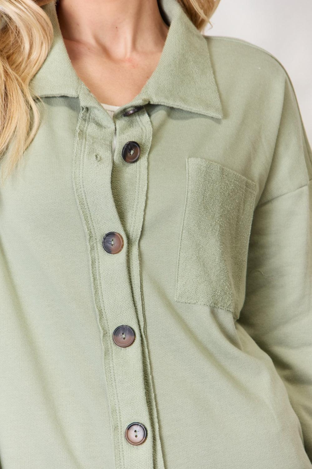 a woman wearing a green shirt with buttons