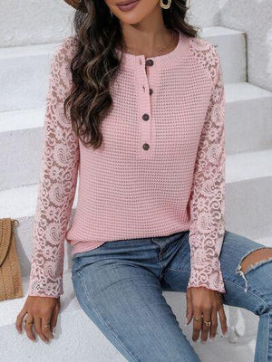 a woman wearing a pink sweater and jeans