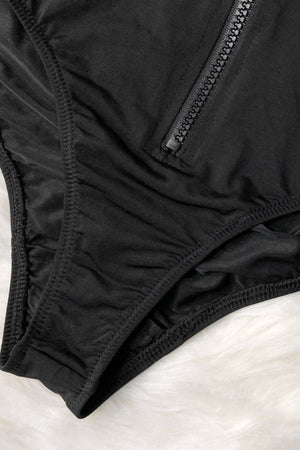 a close up of a black underwear on a white surface