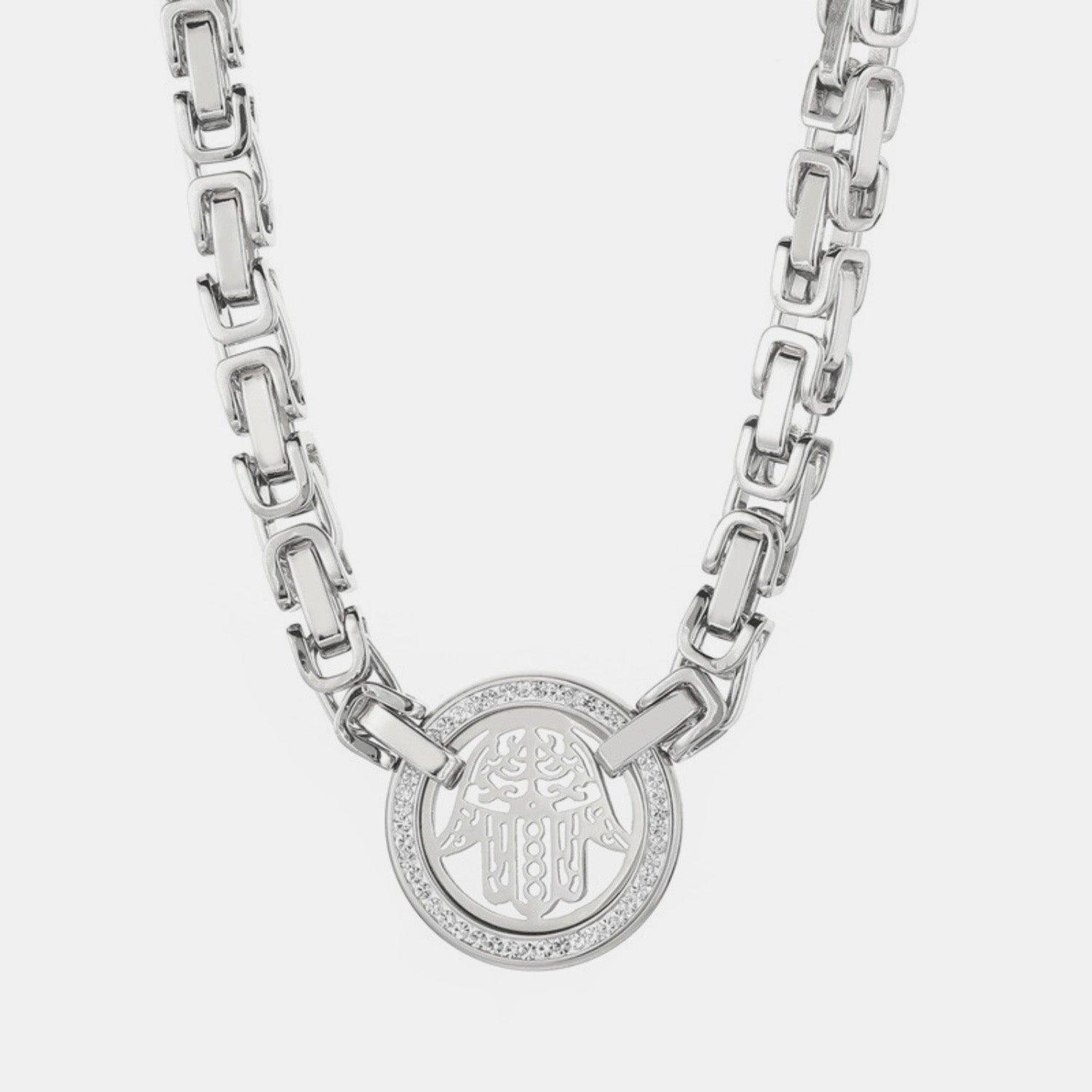 a silver chain with a medallion on it