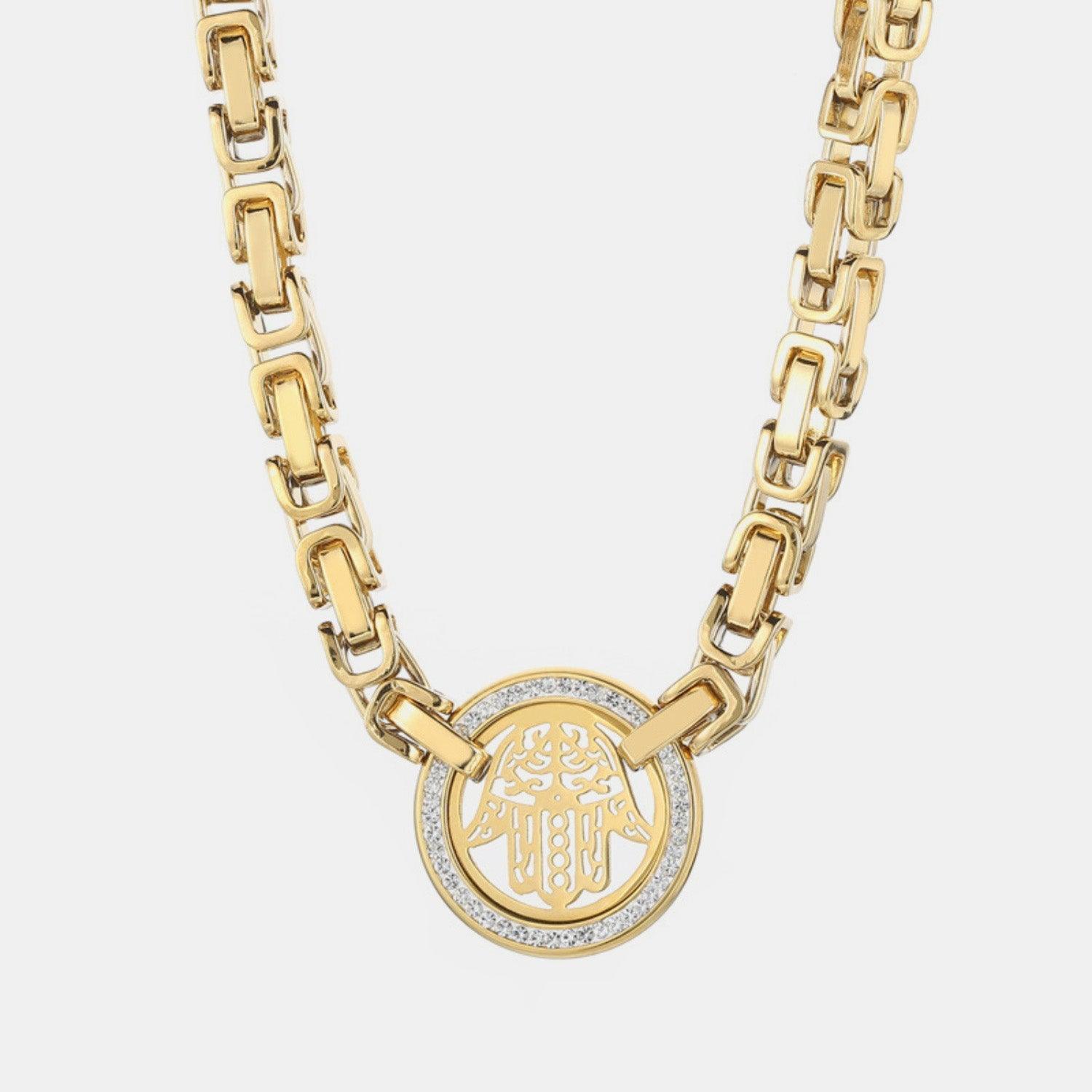 a gold necklace with an emblem on it