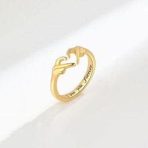 a gold ring with a heart on it