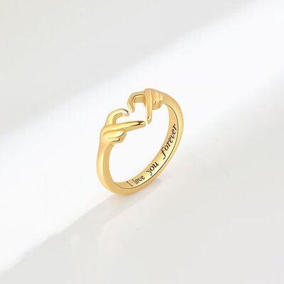 a gold ring with a heart on it