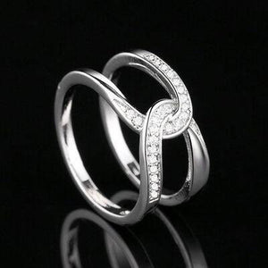 a white gold ring with diamonds on a black background