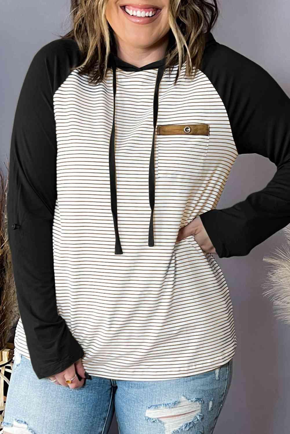 a woman wearing a black and white striped hoodie