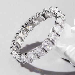 a diamond ring sitting on top of a white flower