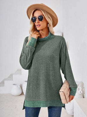 a woman wearing a green sweater and hat