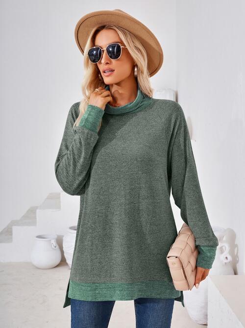 a woman wearing a green sweater and hat