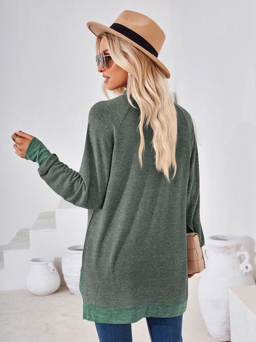 a woman wearing a green sweater and hat