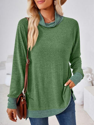 a woman wearing a green sweater and jeans