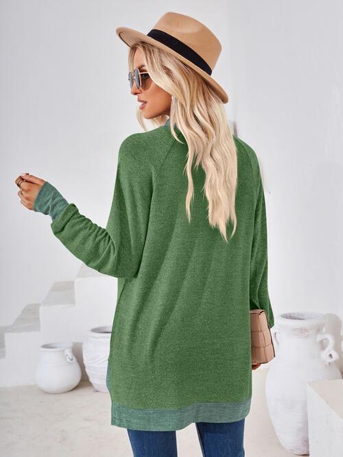 a woman wearing a green sweater and hat