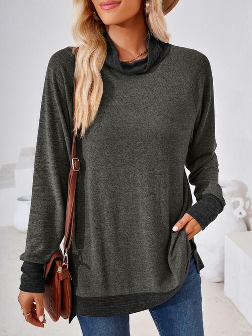 a woman wearing a grey sweater and jeans