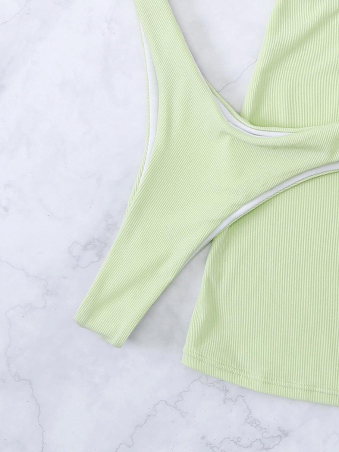 a green sports bra top laying on a marble surface