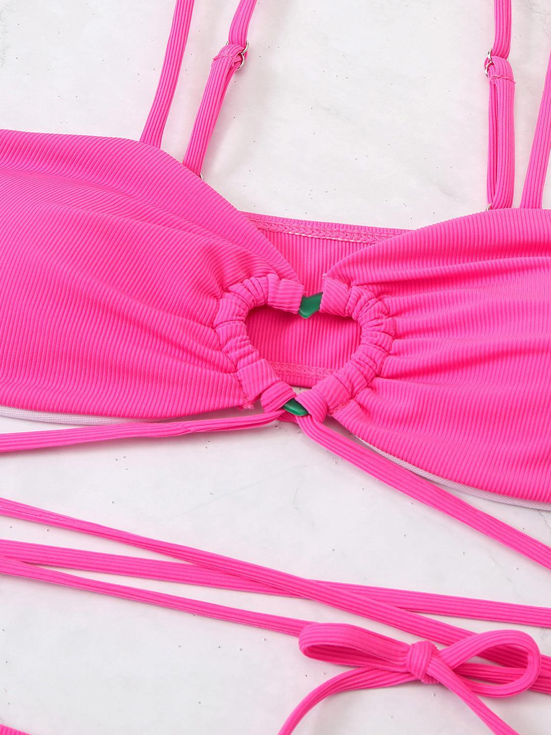 a woman's pink bikini top with a tie around it