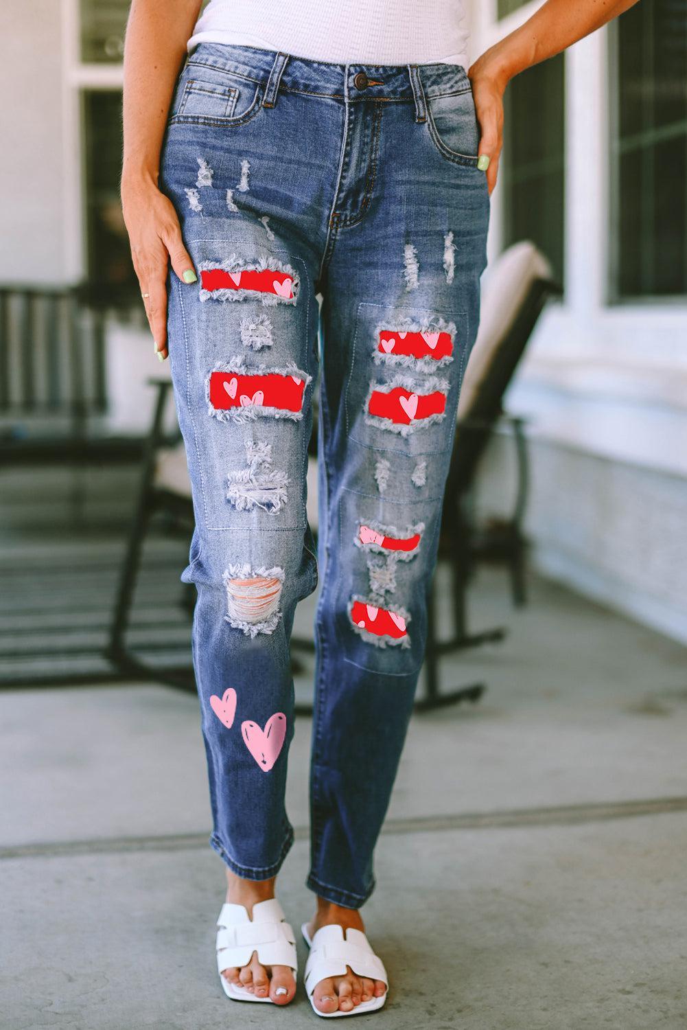 a woman wearing ripped jeans with hearts on them