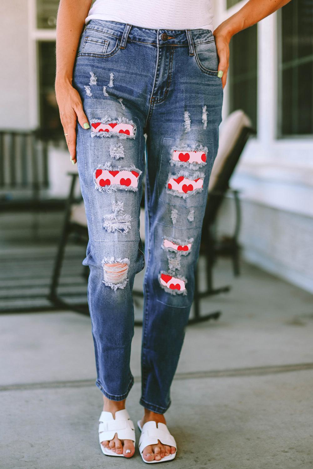 a woman wearing ripped jeans and white shoes
