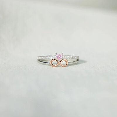 a pink diamond ring on a white surface